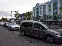 Several taxis parked on a road